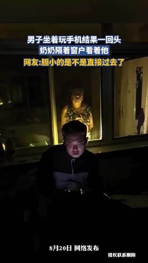 男子坐着玩手机结果一回头，奶奶隔着窗户看着他